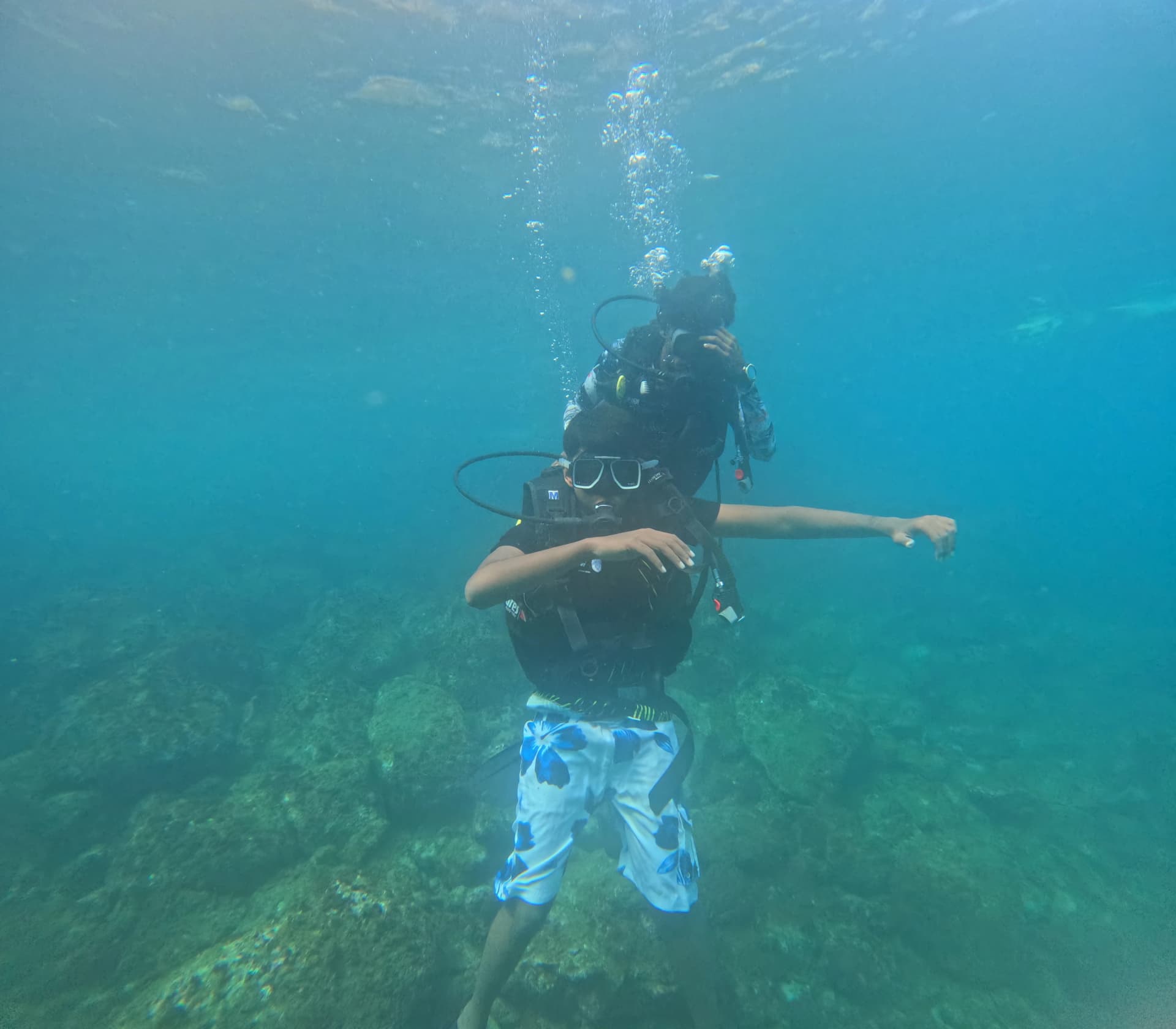 Scuba divers enjoying an underwater diving experience in the clear waters of Netrani Island