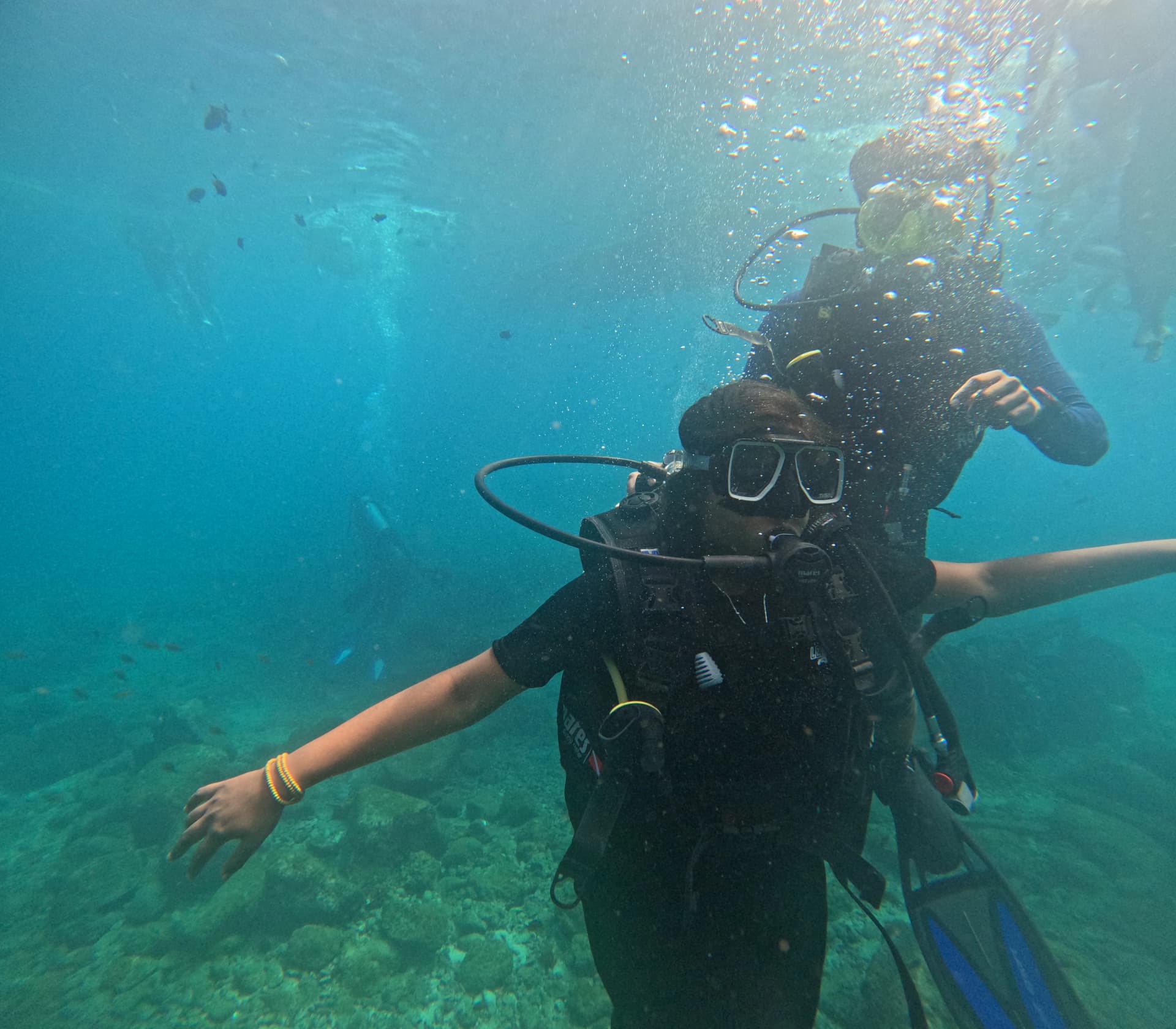 PADI certified dive instructor guiding a first-time scuba diver near Netrani coral reefs