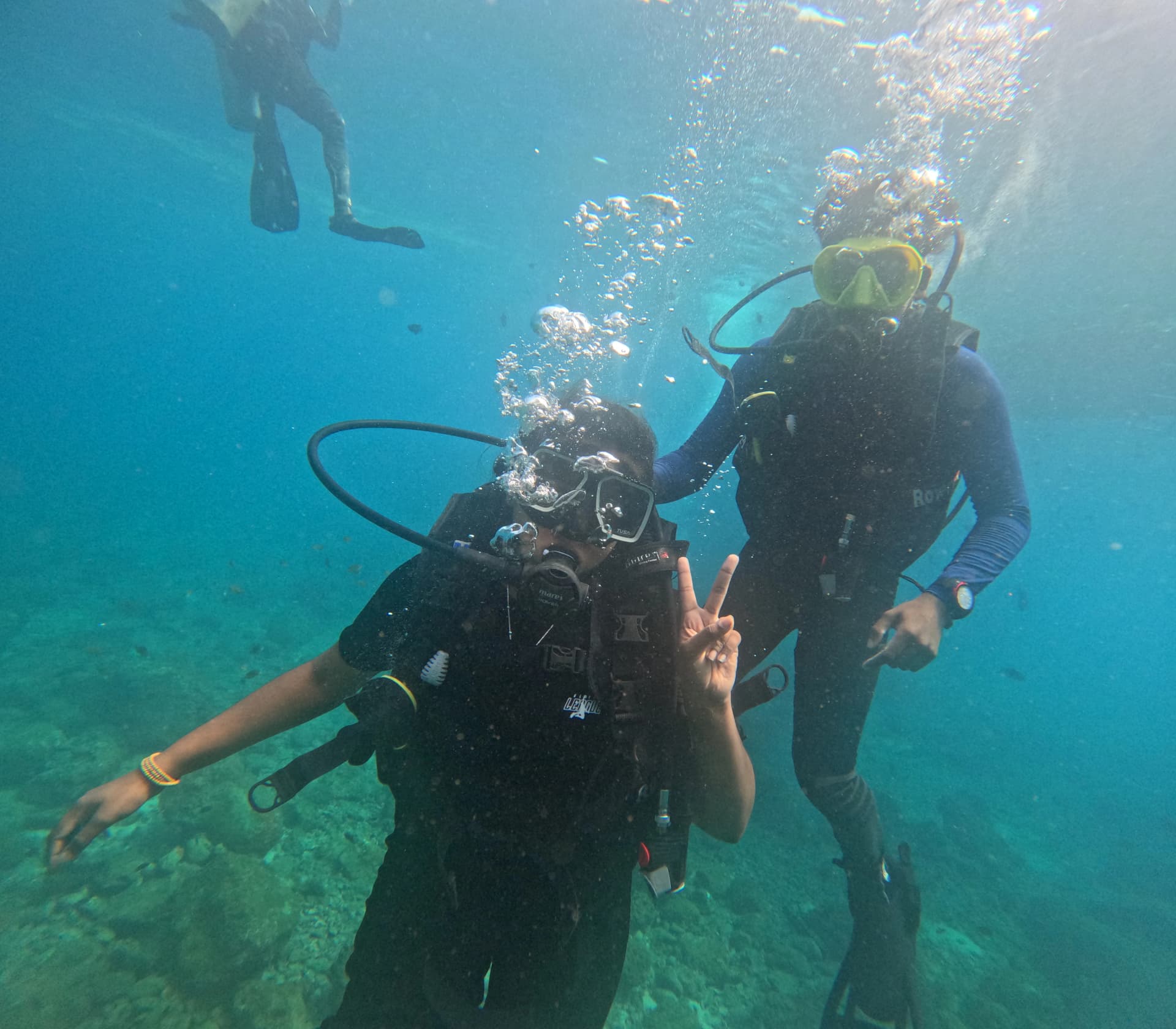 Diver maintaining neutral buoyancy while gliding over underwater rocky pinnacles